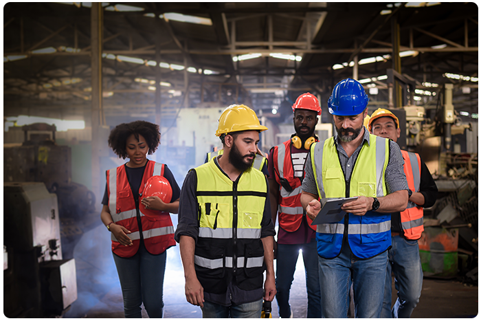 EHS manager and frontline workers walk through a worksite.