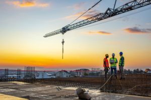 Construction workers conduct an audit at a work site using Intelex software.